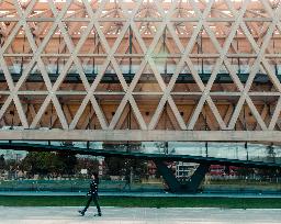 people walking on gray concrete pavement near brown building during daytime
